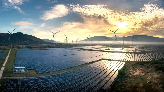 energias-renovables-en-colombia-viu paisaje-al-atardecer-con-paneles-solares-y-aerogeneradores-como-ejemplo-de-energias-renovables-en-colombia